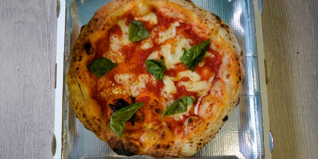A pizza for home delivery is being packaged at the Caputo pizzeria in Naples on April 27.. (AP Photo/Andrew Medichini)