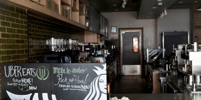 A closed Starbucks coffee shop in the Brooklyn borough of New York, during the COVID-19 coronavirus outbreak. (AP Photo/Mark Lennihan)