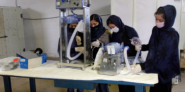 Girls developing two types of cheap ventilator devices using car spare parts to help the fight against the coronavirus pandemic in Herat, west of Kabul, Afghanistan.  (AP Photo/Hamed Safarazi)