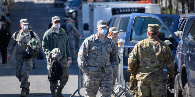 United States Air Force airmen help build a makeshift morgue outside of Bellevue Hospital to handle an expected surge in coronavirus victims on March 27, 2020 in New York City.