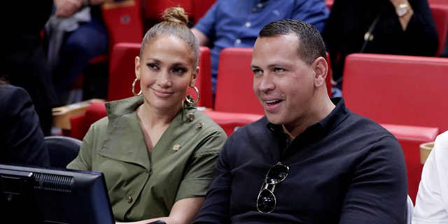 In this Dec. 13, 2019, file photo, Jennifer Lopez and Alex Rodriguez sit courtside during an NBA basketball game between the Miami Heat and the Los Angeles Lakers in Miami.