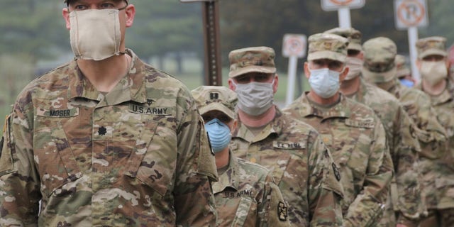 U.S. Army Reserve Urban Augmentation Medical Task Force Soldiers prepare to board buses at Joint Base McGuire-Dix-Lakehurst, New Jersey, to deploy to community hospitals, April 08, 2020.