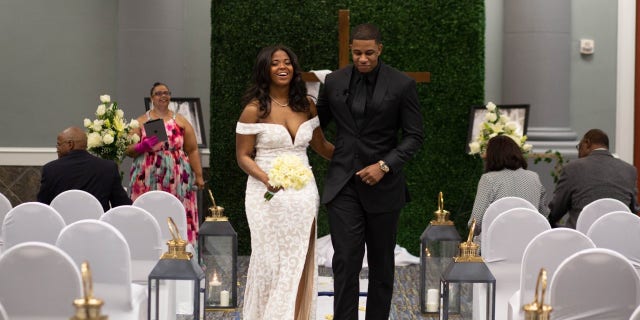 The Smiths walk down the aisle in the presence of a few family members. They say they are grateful for the small ceremony they had and plan on having the real thing in a few months.