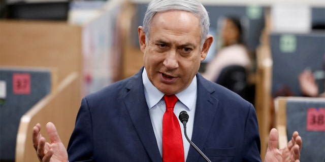 Israeli Prime Minister Benjamin Netanyahu gestures as he delivers a statement during his visit at the Health Ministry national hotline, in Kiryat Malachi, Israel last month. Netanyahu on Monday announced movement restrictions during the upcoming Passover holiday. (REUTERS/Amir Cohen/File Photo)