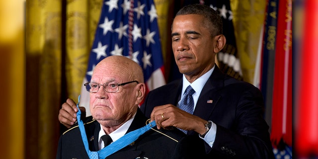 President Barack Obama bestows the Medal of Honor on retired Army Command Sgt. Maj. Bennie G. Adkins in the East Room of the White House in Washington, Monday, Sept. 15, 2014.(AP Photo/Carolyn Kaster)