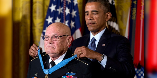 President Barack Obama bestows the Medal of Honor on retired Army Command Sgt. Maj. Bennie G. Adkins in the East Room of the White House in Washington, Monday, Sept. 15, 2014.(AP Photo/Carolyn Kaster)