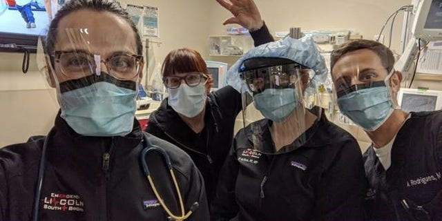 Medical workers posing with masks provided to them via MasksForDocs.