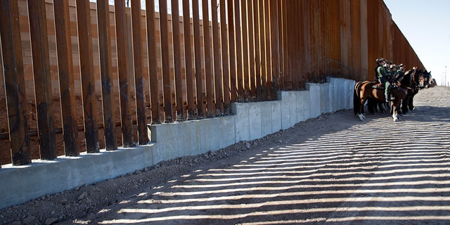 A mounted detachment of the U.S. Border Patrol is seen along the wall during U.S. Department of Homeland Security Secretary Kirstjen Nielsen's visit to the El Centro Sector in Calexico, California, in 2018. REUTERS/Earnie Grafton