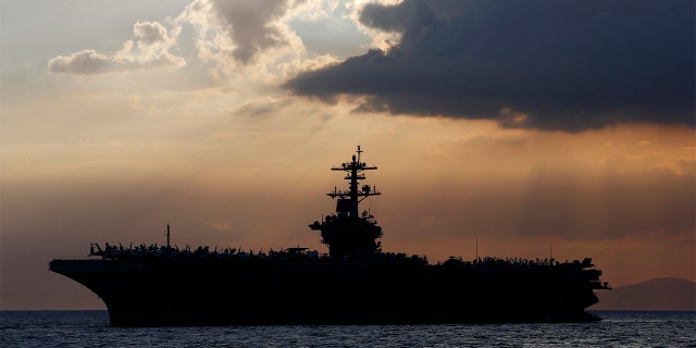 FILE - In this April 13, 2018, file photo the USS Theodore Roosevelt aircraft carrier is anchored off Manila Bay west of Manila, Philippines. (AP Photo/Bullit Marquez, File)