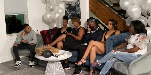 In this still image from video provided by the NFL, CeeDee Lamb talks on a phone in Houston during the NFL football draft Thursday, April 23, 2020. Lamb was chosen by the Dallas Cowboys in the first round. (NFL via AP)