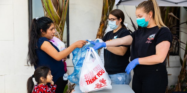 Volunteers at the LA Dream Center hand out meals and essential items.