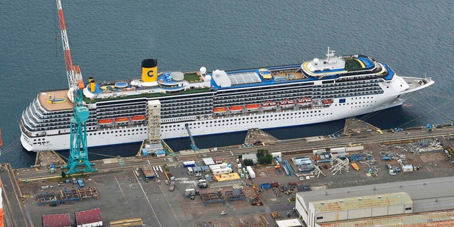 Italian-operated cruise ship the Costa Atlantica is anchored at a port in Nagasaki, southern Japan, Thursday, April 23, 2020. The Costa Atlantica docked since late January is struck by an onboard coronavirus outbreak in which dozens of crew members found to have infected, sending health officials in the southern Japanese city almost free of the virus scrambling to find clues to how the infections started on the ship. (Kyodo News via AP)
