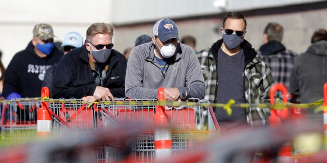 Shoppers wait in line outside a Coscto in Salt Lake City, Utah, on April 4.