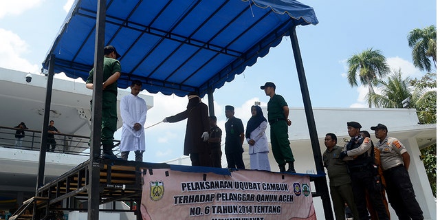 Sharia Service Officers give flogging to a man who violates Islamic Sharia law in Banda Aceh City.