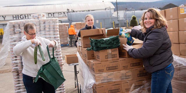 Food Bank of the Southern Tier volunteers load up cars at a "no-contact" food distribution event during the COVID-19 pandemic.