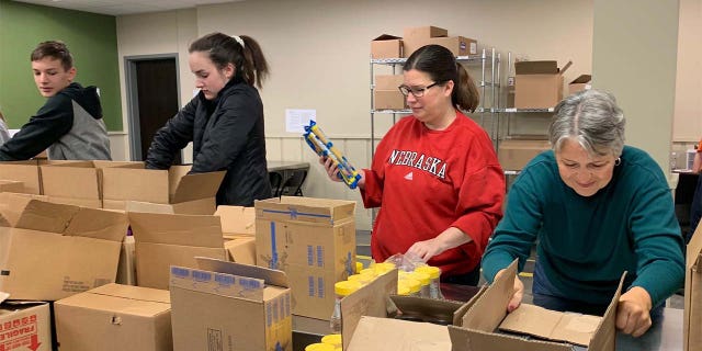 Volunteers at Food Bank of the Heartland pack coronavirus emergency boxes. (Feeding America)