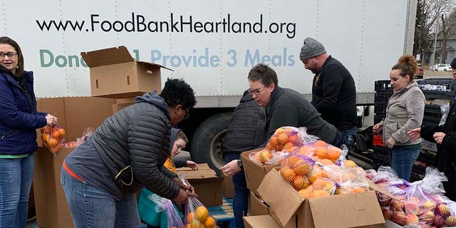 Food Bank for the Heartland volunteers and staff distribute food at an emergency drive-up mobile pantry in Omaha during the COVID-19 pandemic.  (Food Bank for the Heartland) 