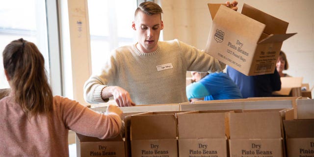 Volunteers at Food Bank of the Southern Tier in Upstate New York pac emergency food boxes and bag produce for drop-and-go delivery at mobile food pantry sites and for distribution through regional school districts.