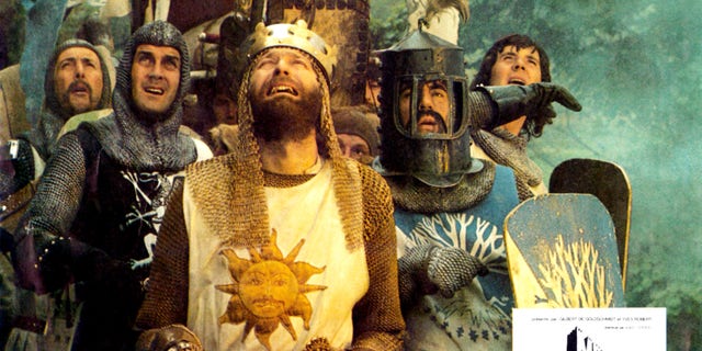 'Monty Python And The Holy Grail' -- Rear from left: Eric Idle, Michael Palin, Center from left: John Cleese, Terry Jones (helmet), Graham Chapman as King Arthur (front), 1975.