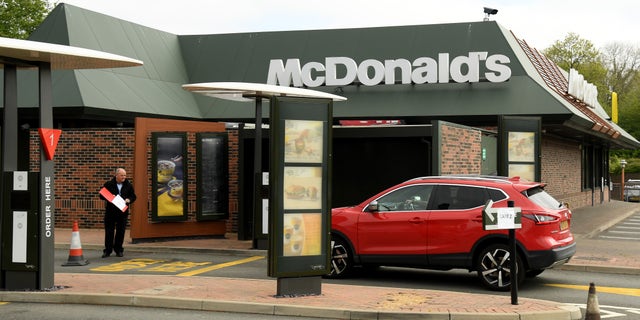 A car arrives at the COVID-19 testing center at McDonald's in Meridian Business Park on April 25 in Leicester, England.