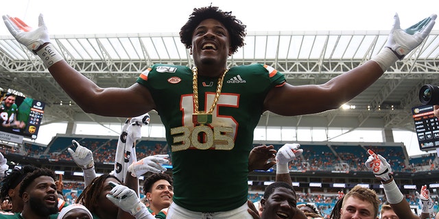 Miami Hurricanes defensive lineman Gregory Rousseau (15) celebrates wearing the turnover chain during the first quarter of a football game against the Central Michigan Chippewas at Hard Rock Stadium.