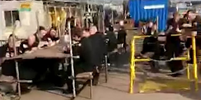 Video shared by Forces Compare showed HMS Trenchant sailors eating and listening to music while sitting on the dock after their submarine came ashore.