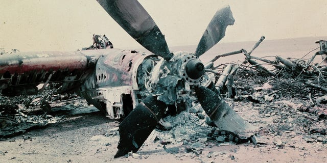 The burned out wreckage of a U.S. aircraft lies in the desert some 300 miles south of Tehran after the abortive commando-style raid into Iran, April 1980, aimed at freeing the American hostages being held in Tehran. The rescue mission fell apart when several helicopters failed and a helicopter and C141 transport plane collided. At least 8 U.S. servicemen died in the mission. (AP Photo)
