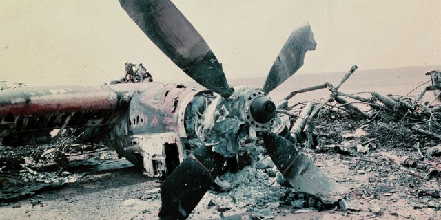 The burned out wreckage of a U.S. aircraft lies in the desert some 300 miles south of Tehran after the abortive commando-style raid into Iran, April 1980, aimed at freeing the American hostages being held in Tehran. The rescue mission fell apart when several helicopters failed and a helicopter and C141 transport plane collided. At least 8 U.S. servicemen died in the mission. (AP Photo)