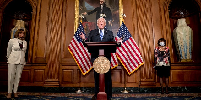 House Majority Leader Steny Hoyer of Md., center, accompanied by House Speaker Nancy Pelosi of Calif., left, and House Financial Services Committee Chairwoman Maxine Waters, speaks during a signing ceremony for the Paycheck Protection Program and Health Care Enhancement Act, H.R. 266, after it passed the House on Capitol Hill, Thursday, April 23, 2020, in Washington. (AP Photo/Andrew Harnik)