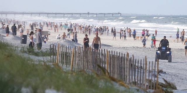People crowded the beaches in its first open hour on April 17, 2020 in Jacksonville Beach, Fl. Jacksonville Mayor Lenny Curry opened the beaches to residents for limited activities for the first time in weeks since closing them to the public due to the Coronavirus (COVID-19) outbreak. Jacksonville Beach became the first beach in the country to reopen. 