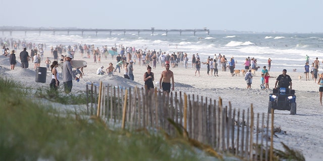 People crowded the beaches in its first open hour on April 17, 2020 in Jacksonville Beach, Fl. Jacksonville Mayor Lenny Curry opened the beaches to residents for limited activities for the first time in weeks since closing them to the public due to the Coronavirus (COVID-19) outbreak. Jacksonville Beach became the first beach in the country to reopen. 