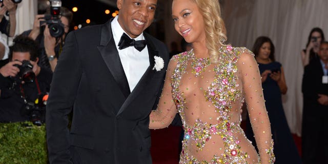 In this May 4, 2015, file photo, Jay-Z, left, and Beyonce arrive at The Metropolitan Museum of Art's Costume Institute benefit gala celebrating "China: Through the Looking Glass" in New York. (Photo by Evan Agostini/Invision/AP, File)