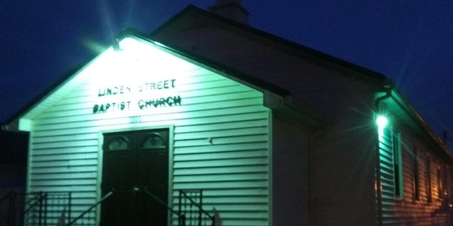 The Linden Street Baptist Church in Richmond, Ky., is lit up green to show compassion amid the coronavirus pandemic.
