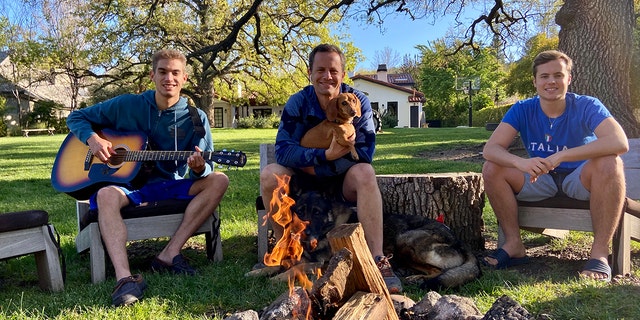 ‘Growing Pains’ star Kirk Cameron is seen quarantining with his sons Luke, left, and James, right as the trio gather around a backyard campfire amid the coronavirus pandemic
