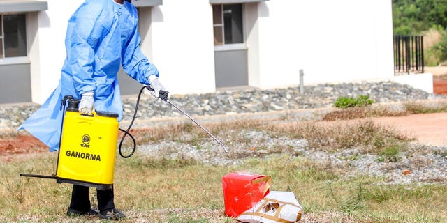 A laboratory staff disinfects box carrying COVID-19 test samples that were delivered via drone.