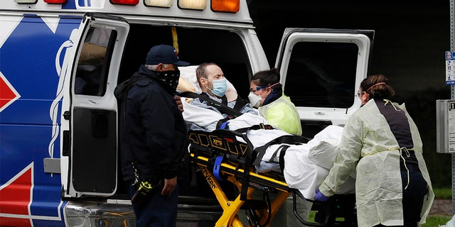 A patient is evacuated from the Magnolia Rehabilitation and Nursing Center in Riverside, Calif., Wednesday, April 8, 2020. (AP Photo/Chris Carlson)