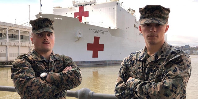 U.S. Marine Sgt. Austin Loppe, left, and U.S. Marine Lance Cpl. Colton Flach, right, are assigned to II Marine Expeditionary Force as part of a Marine security detachment supporting the USNS Comfort. (U.S. Navy photo by Ensign James Caliva)