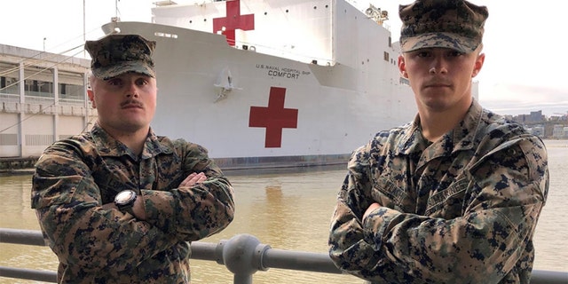 U.S. Marine Sgt. Austin Loppe, left, and U.S. Marine Lance Cpl. Colton Flach, right, are assigned to II Marine Expeditionary Force as part of a Marine security detachment supporting the USNS Comfort. (U.S. Navy photo by Ensign James Caliva)