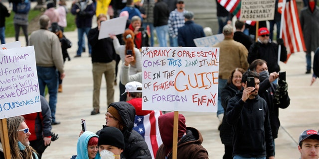 People protest against excessive quarantine amid the coronavirus pandemic at the Michigan State Capitol in Lansing, Michigan on April 15, 2020. - The protest was organized by Michiganders Against Excessive Quarantine several days after Michigan Governor Gretchen Whitmer extended her order through April 30 and took the requirements of staying home a step further, banning crossing the street to visit with neighbors or driving to see friends, among other things mandatory closure to curtail Covid-19. (Photo by JEFF KOWALSKY / AFP) (Photo by JEFF KOWALSKY/AFP via Getty Images)