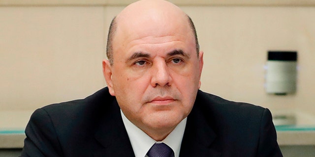 Russian Prime Minister Mikhail Mishustin says he has tested positive for the new coronavirus and has told President Vladimir Putin he will self-isolate. (Dmitry Astakhov, Sputnik, Kremlin Pool Photo via AP)