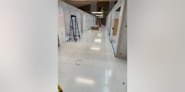 In the lobby of The Mount Sinai Hospital on Manhattan's Upper East Side (pictured above), officials are building additional rooms to handle an overflow of COVID-19 patients.