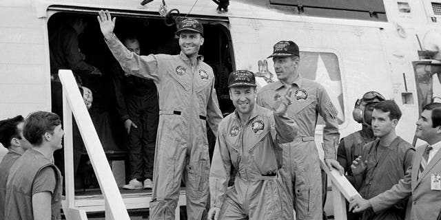 The Apollo 13 crewmembers step aboard the USS Iwo Jima, prime recovery ship for the mission, following splashdown and recovery operations in the South Pacific Ocean. Exiting the helicopter which made the pick-up some four miles from the Iwo Jima are (from left) astronauts Fred Haise, lunar module pilot; Jim Lovell., commander; and Jack Swigert, command module pilot.