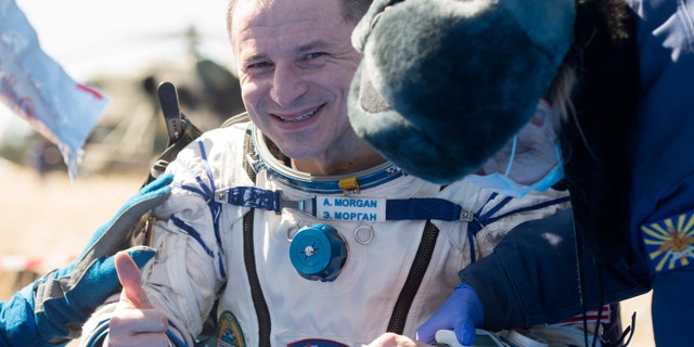 In this handout photo released by Gagarin Cosmonaut Training Centre (GCTC), Roscosmos space agency, U.S. astronaut Andrew Morgan gestures shortly after the landing of the Russian Soyuz MS-15 space capsule near Kazakh town of Dzhezkazgan, Kazakhstan, Friday, April 17, 2020.