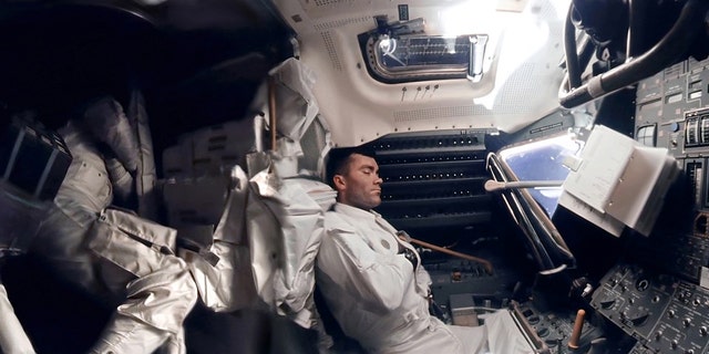 The panoramic hi-def image of interior of the Apollo 13 Lunar Module. Astronaut Fred Haise (right) is napping, while Jack Swigert can be seen curled up in the storage area. Commander Jim Lovell's hand can be seen in the left of the picture.