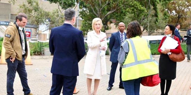 U.S. Ambassador to South Africa, Lana Marks, speaks with embassy staffers ahead of the evacuation flight of U.S. citizens in Johannesburg.