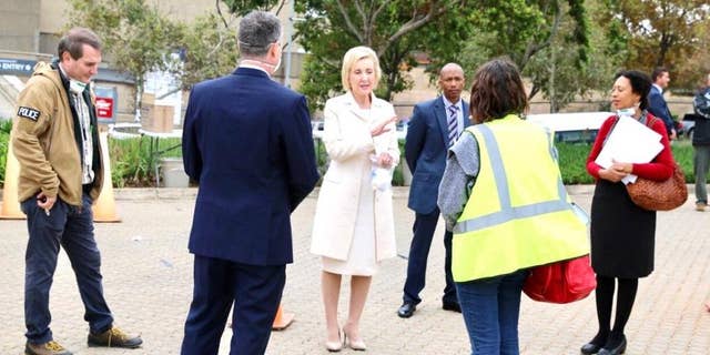 U.S. Ambassador to South Africa, Lana Marks, speaks with embassy staffers ahead of the evacuation flight of U.S. citizens in Johannesburg.