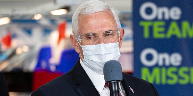 Vice President Mike Pence speaks during a visit to the General Motors/Ventec ventilator production facility with Indiana Gov. Eric Holcomb in Kokomo, Ind., Thursday, April 30, 2020. (AP Photo/Michael Conroy)
