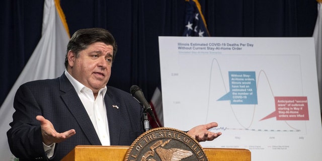FILE - In this April 23, 2020 file photo, Gov. J.B. Pritzker announces an extension of the stay at home order for Illinois as well as a mandatory face covering order at his daily Illinois coronavirus update at the Thompson Center. Illinois State Rep. Darren Bailey, R-Xenia filed suit against the order, and a judge in southern Illinois ruled Monday, April 27, 2020, that the Illinois governor's order to stem the spread of the coronavirus exceeds his emergency authority and violates individual civil rights. (Tyler LaRiviere/Chicago Sun-Times via AP File)