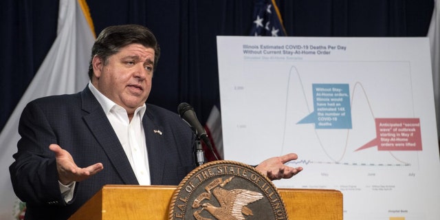 In this April 23, 2020 file photo, Gov. J.B. Pritzker announces an extension of the stay at home order for Illinois as well as a mandatory face covering order at his daily Illinois coronavirus update at the Thompson Center. Illinois State Rep. Darren Bailey, R-Xenia filed suit against the order, and a judge in southern Illinois ruled Monday, April 27, 2020, that the Illinois governor's order to stem the spread of the coronavirus exceeds his emergency authority and violates individual civil rights. (Tyler LaRiviere/Chicago Sun-Times via AP File)