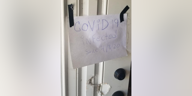Joshua Price, 28, was arrested by officers on April 16 who discovered a sign written in blue ink that read, “COVID 19 infected since 4/8/20," police said.